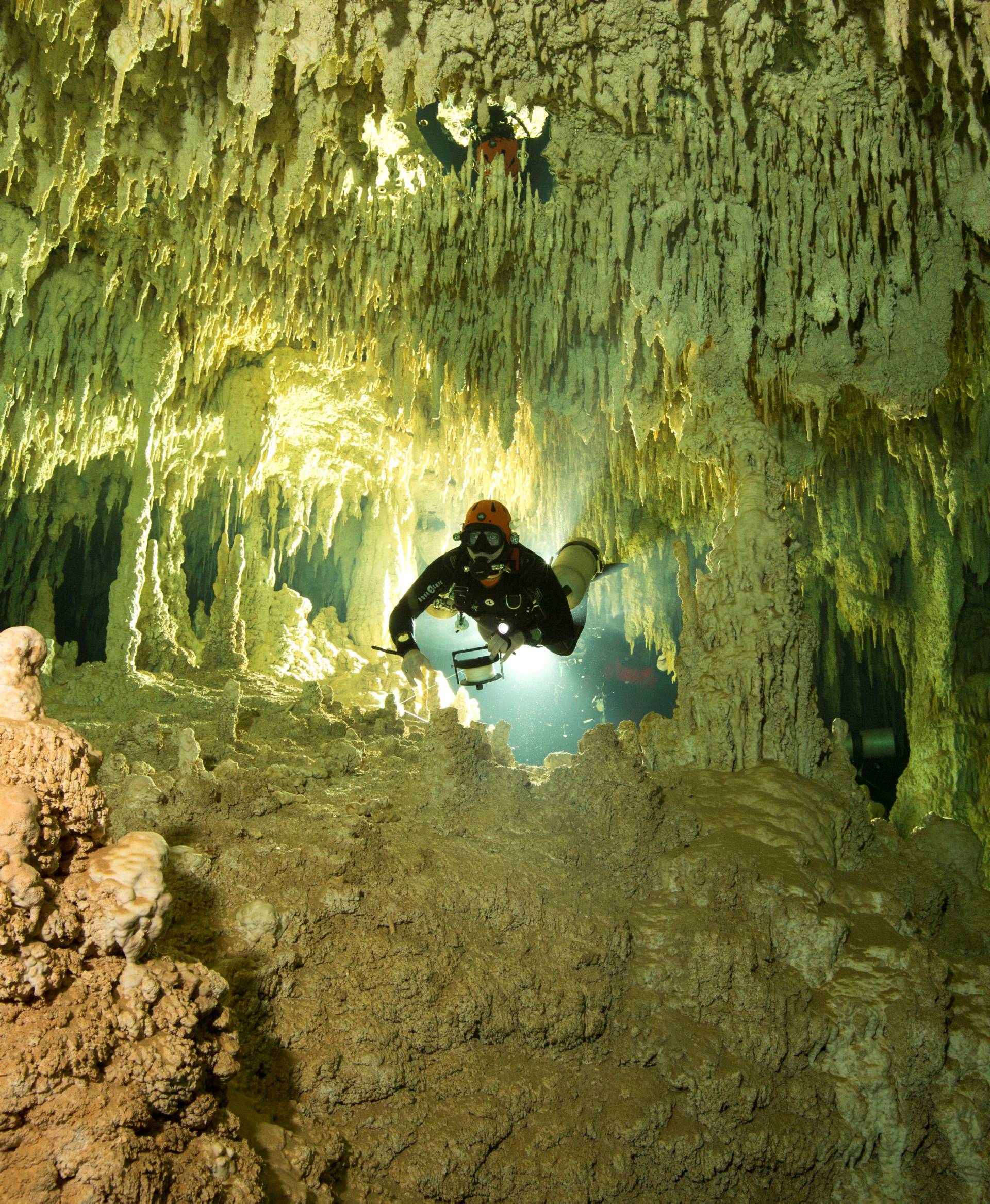 A scuba diver measures the length of Sac Aktun underwater cave system as part of the Gran Acuifero Maya Project near Tulum