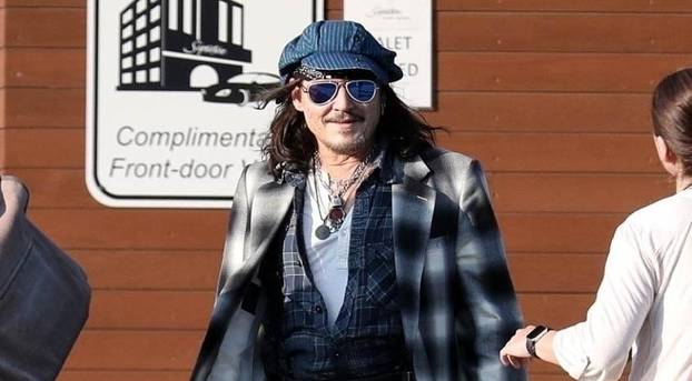 *EXCLUSIVE* Johnny Depp uses a cane while arriving in Boston for his Hollywood Vampires show after being forced to reschedule due to ankle fracture.