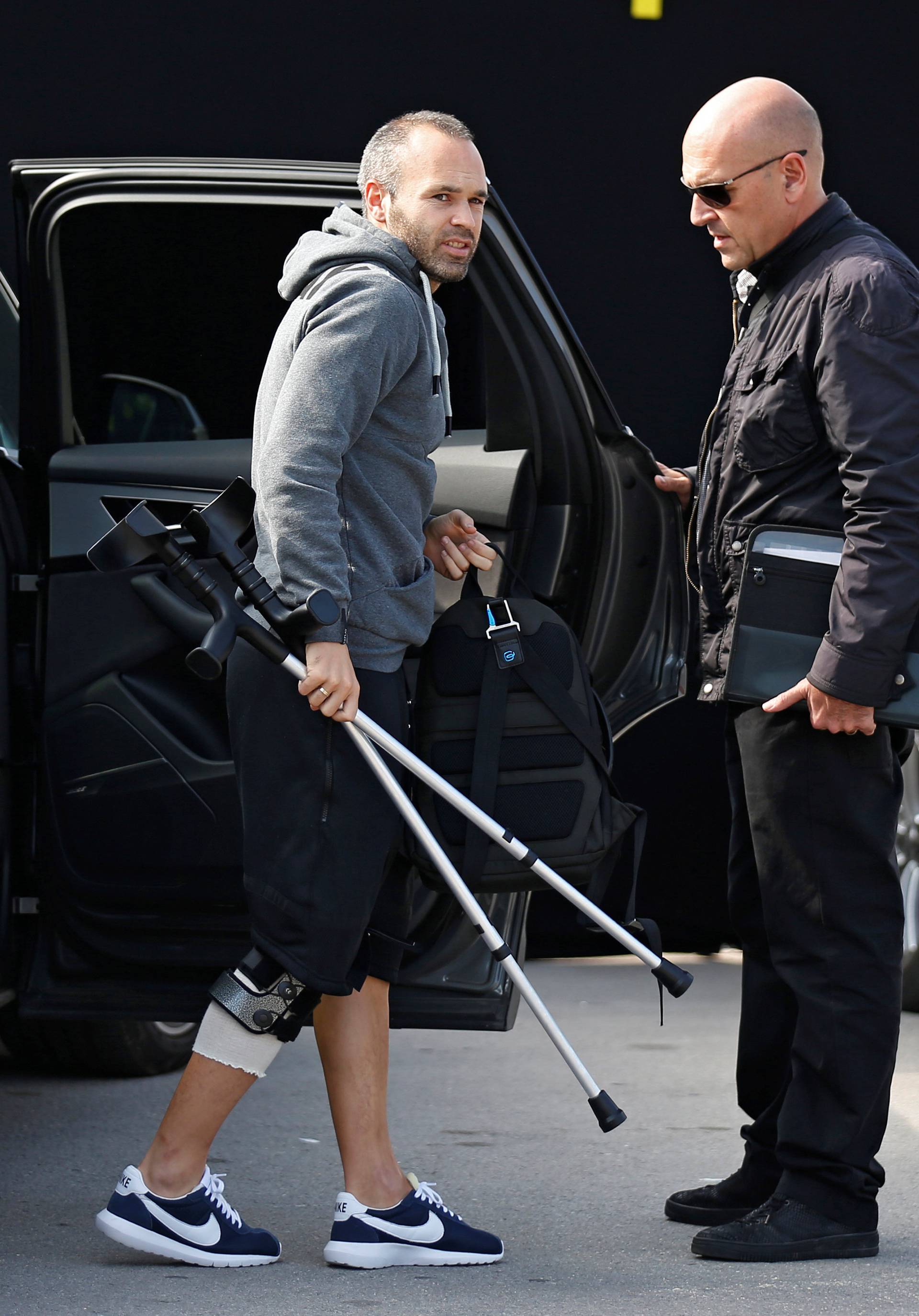 Barcelona's injured soccer player Iniesta takes part in a commercial event near Camp Nou stadium in Barcelona