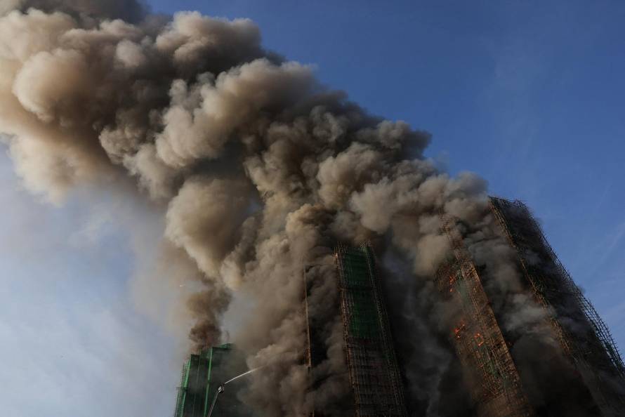 Flames engulf bamboo scaffolding across multiple buildings at Wang Fuk Court housing estate, in Tai Po