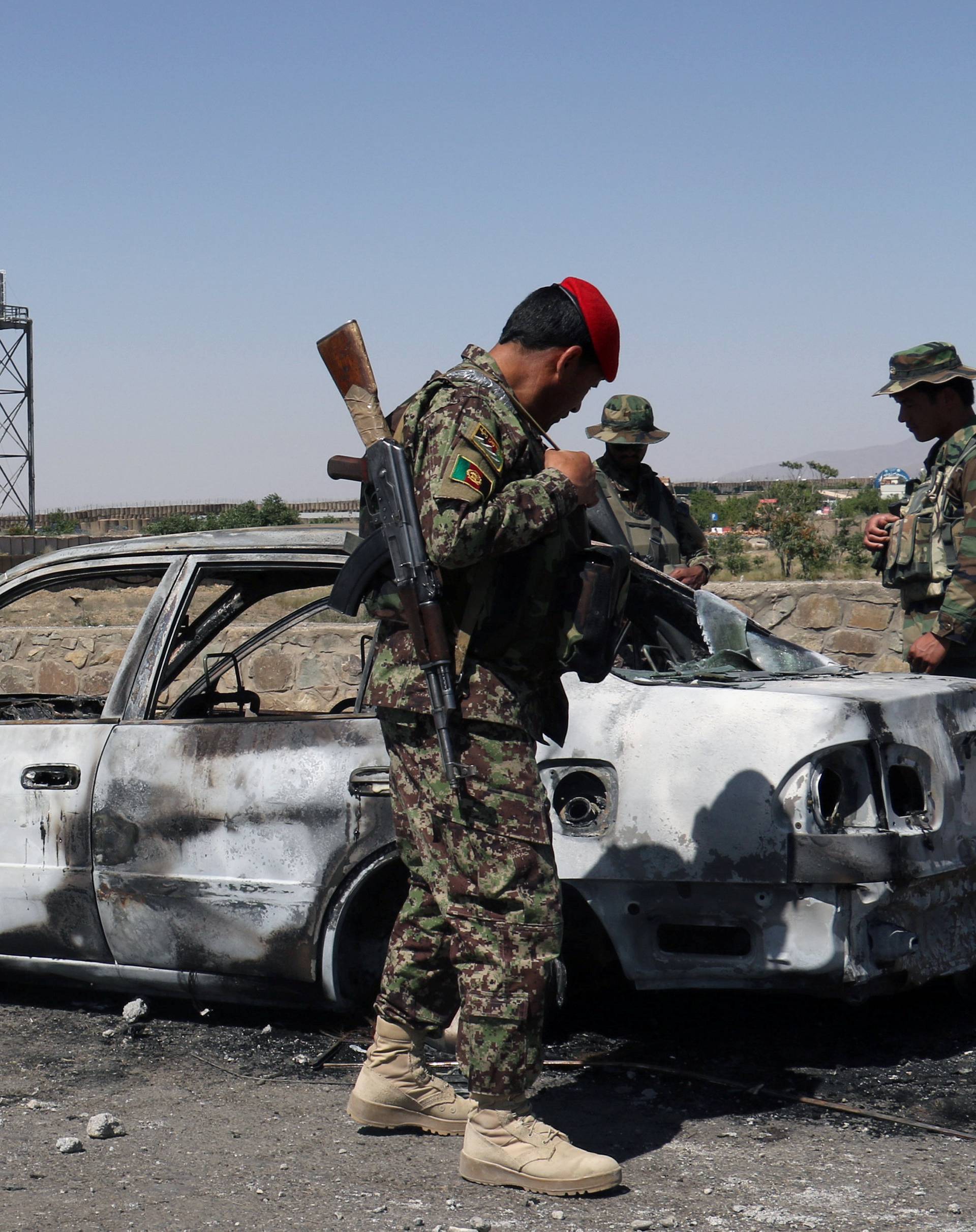 Afghan security forces inspect car after a suicide bomb blast in Paktia Province