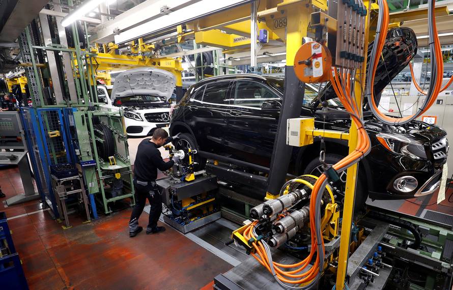 FILE PHOTO: An employee of German car manufacturer Mercedes Benz installs wheels at a A-class model at the production line at the Daimler factory in Rastatt