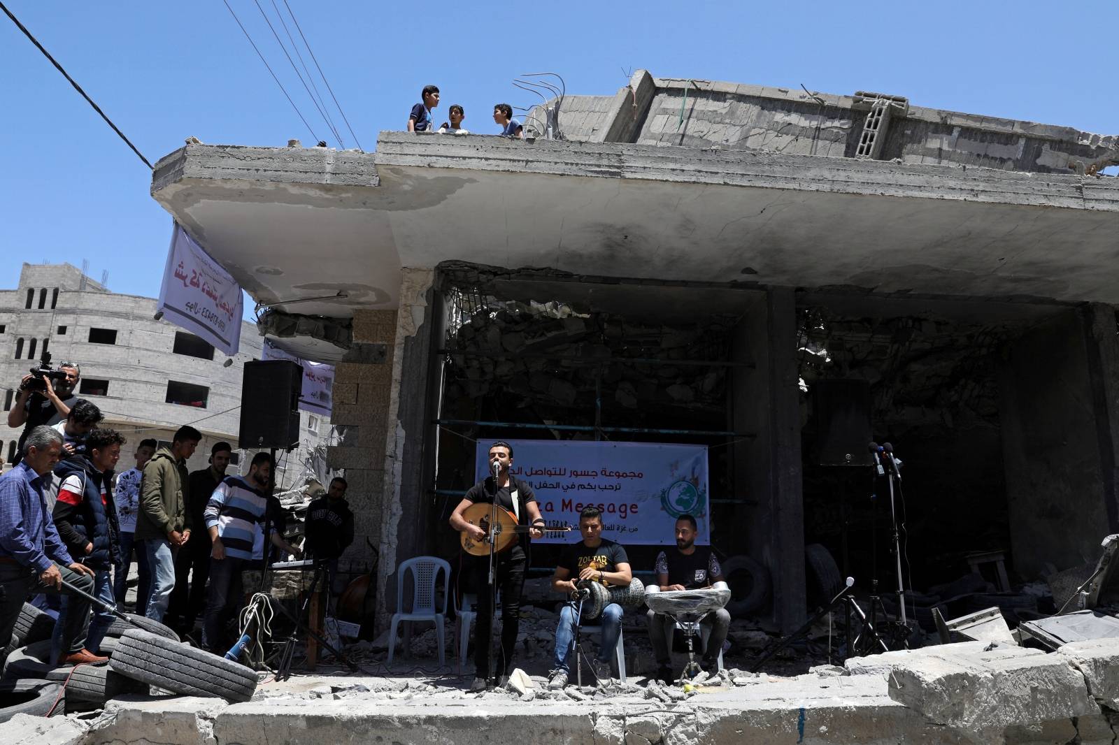 Palestinian singer performs during a musical event calling to boycott the Eurovision Song Contest hosted by Israel, in Gaza City