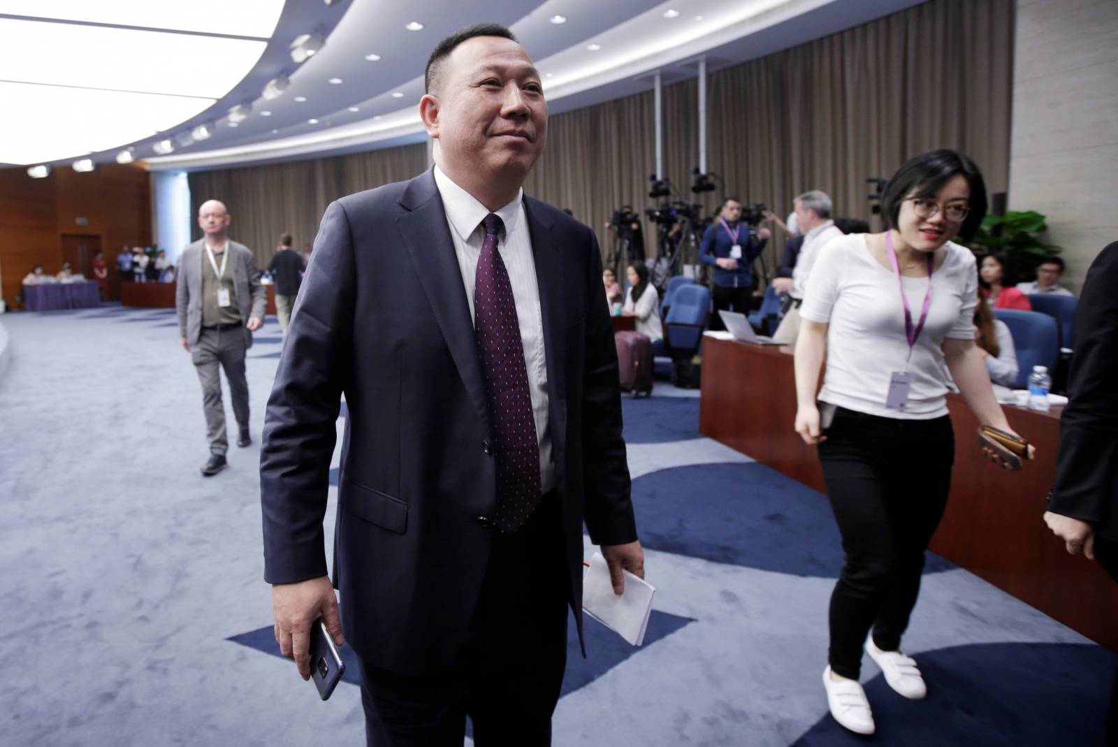 Huawei's Chief Legal Officer Song Liuping leaves after a news conference in Shenzhen