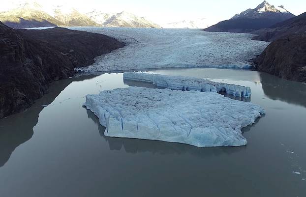 Two new icebergs are seen after breaking off from the Grey glacier in Patagonia