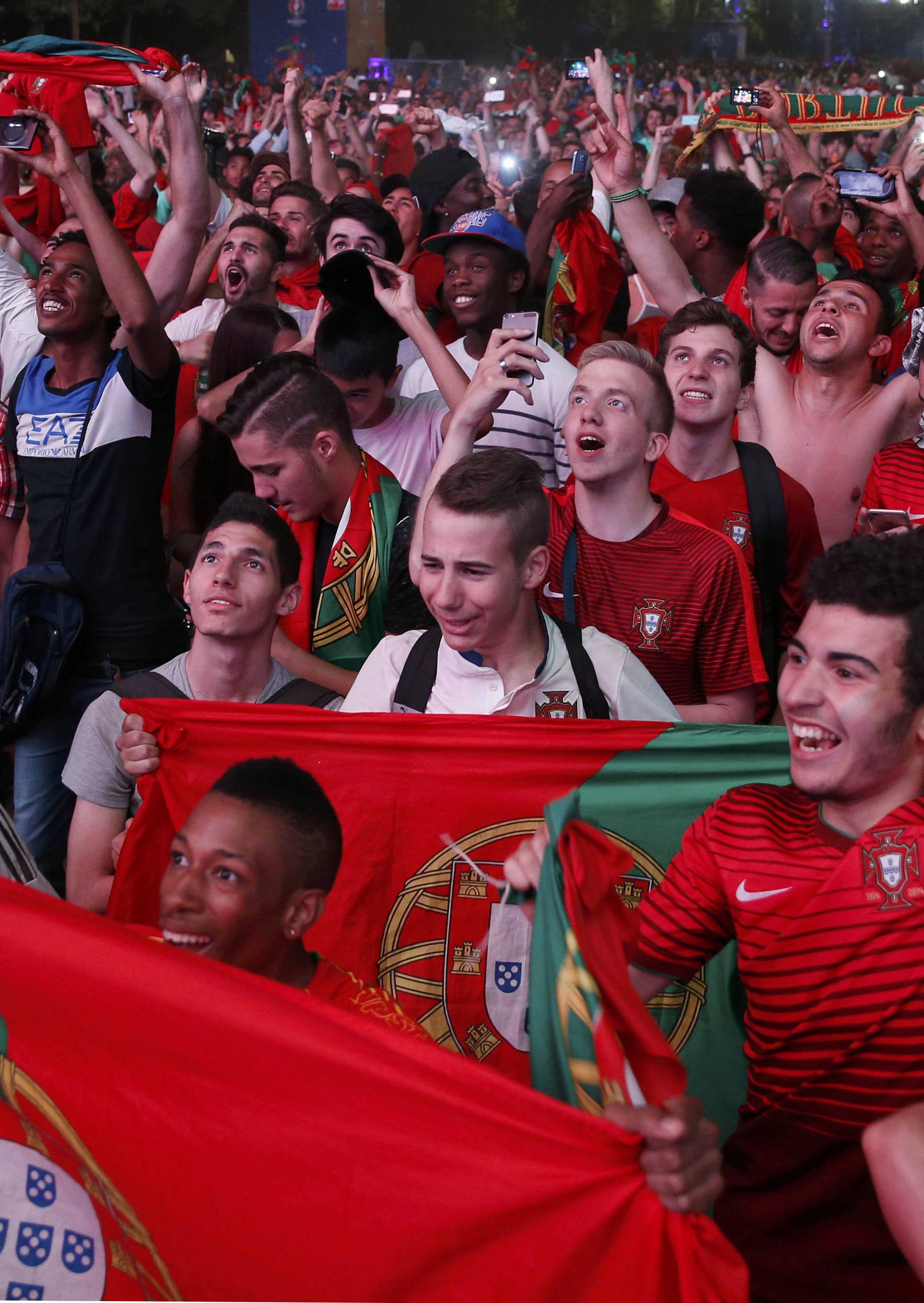 Portugal fans react at Paris fan zone during a EURO 2016 final soccer match       