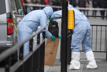 Forensic investigators recover a rucksack after man was arrested on Whitehall in Westminster in central London