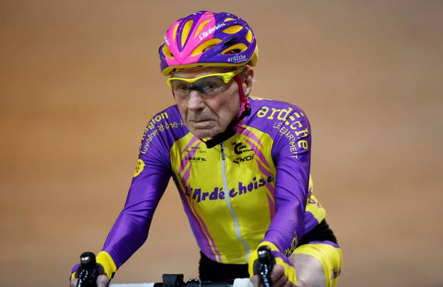 FILE PHOTO: French cyclist Robert Marchand, aged 105, rides on his way to cover 22.528 km (14.08 miles) in one hour to set a new record at the indoor Velodrome National in Montigny-les-Bretonneux
