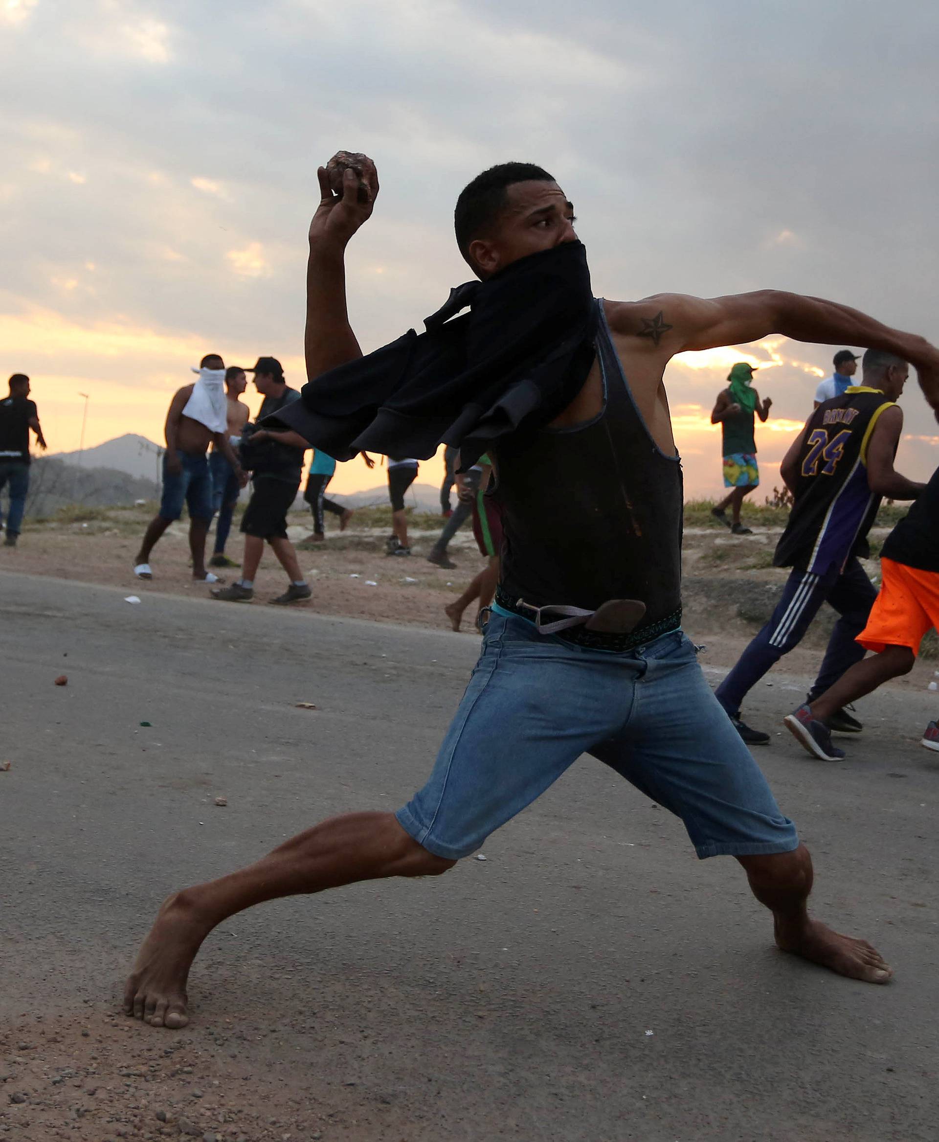 People hurl stones at the border between Venezuela and Brazil in Pacaraima
