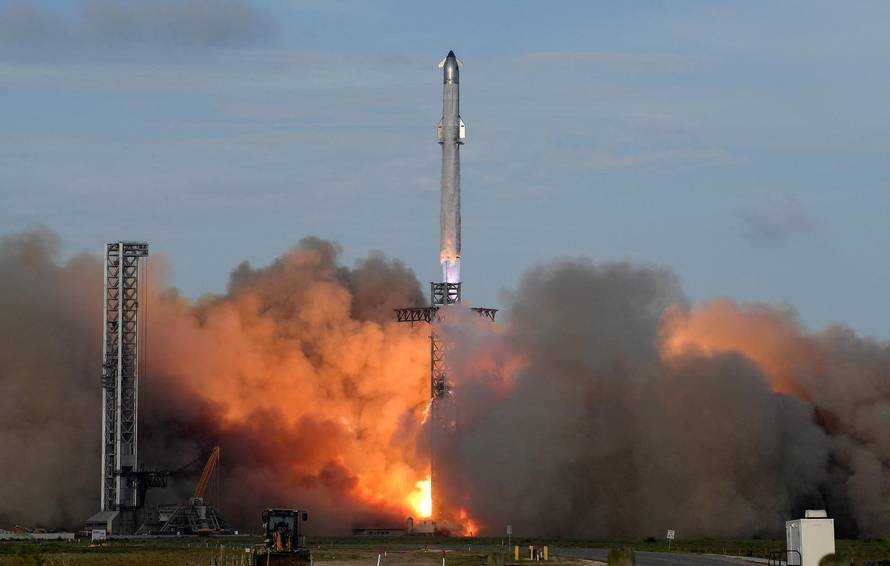 A SpaceX Super Heavy booster carrying the Starship spacecraft lifts off on its 10th test flight