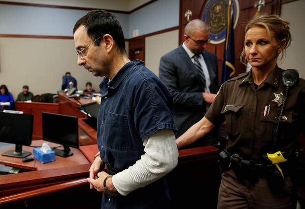 Larry Nassar, a former team USA Gymnastics doctor who pleaded guilty in November 2017 to sexual assault charges, listens to a victim during his sentencing hearing in Lansing, Michigan