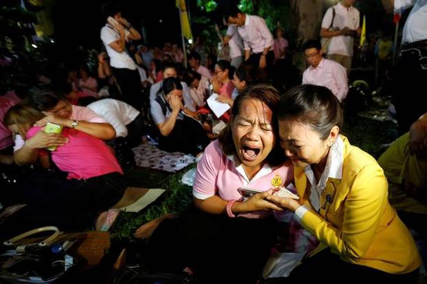 People weep after an announcement that Thailand