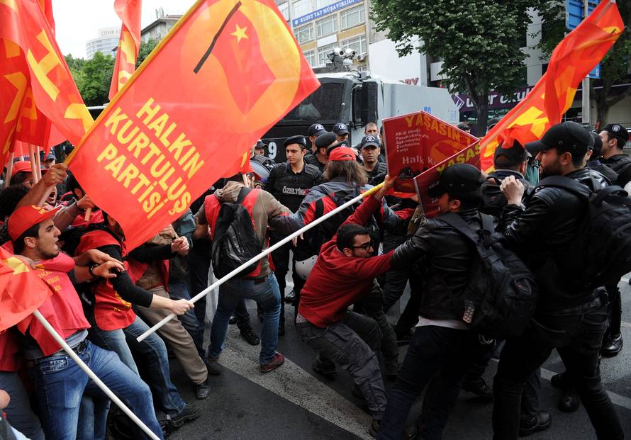 Turkish riot police scuffle with a group of protesters as they attempted to defy a ban and march on Taksim Square