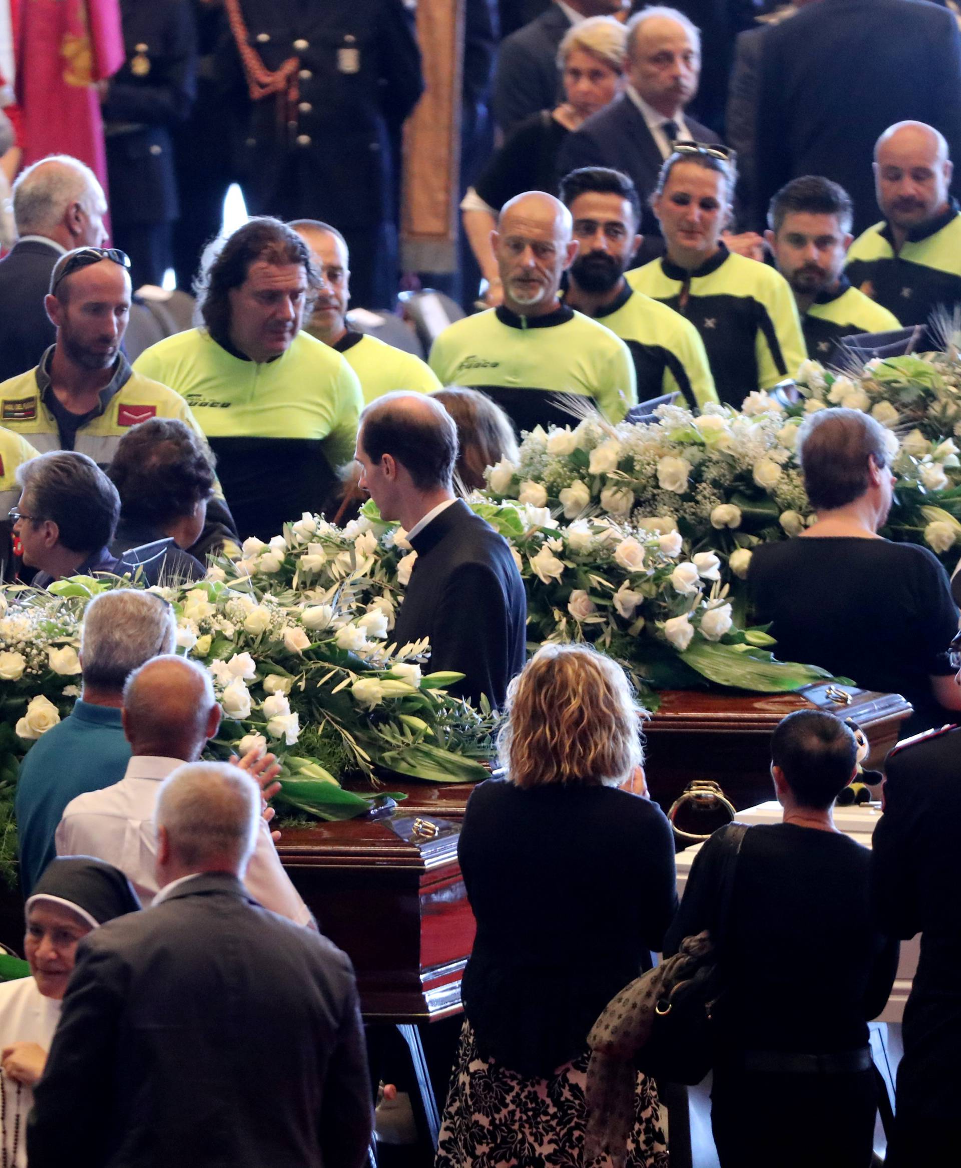 Firefighters arrive to pay their respects to the victims of the Morandi Bridge collapse, before the state funeral at the Genoa Trade Fair and Exhibition Centre in Genoa