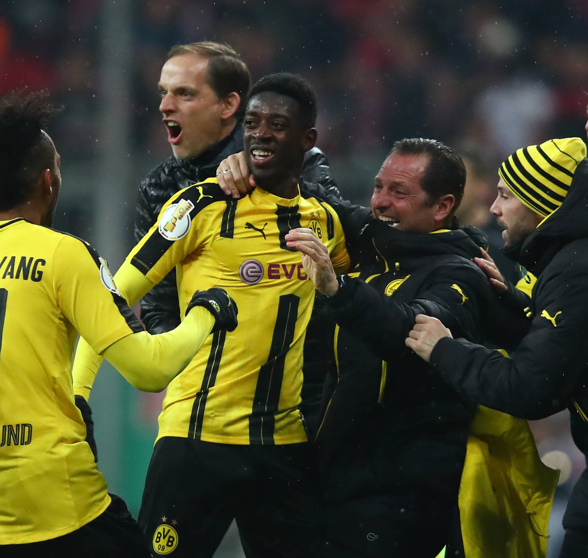 Borussia Dortmund's Ousmane Dembele celebrates scoring their third goal with coach Thomas Tuchel and coaching staff
