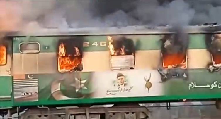 Video grab of a fire burning in a train carriage after a gas canister passengers were using to cook breakfast exploded, near the town of Rahim Yar Khan