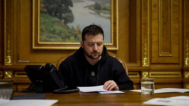 FILE PHOTO: Ukraine's President Zelensky speaks with German Chancellor Scholz via phone line in Kyiv