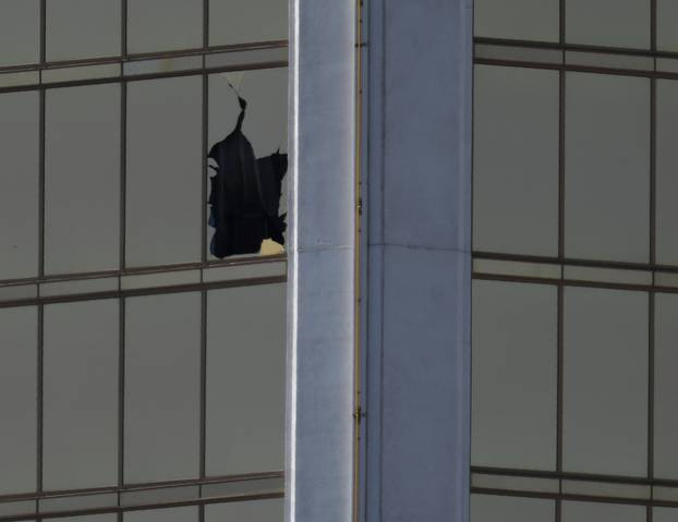 A broken window is seen at The Mandalay Bay Resort and Casino following a mass shooting at the Route 91 Festival in Las Vegas