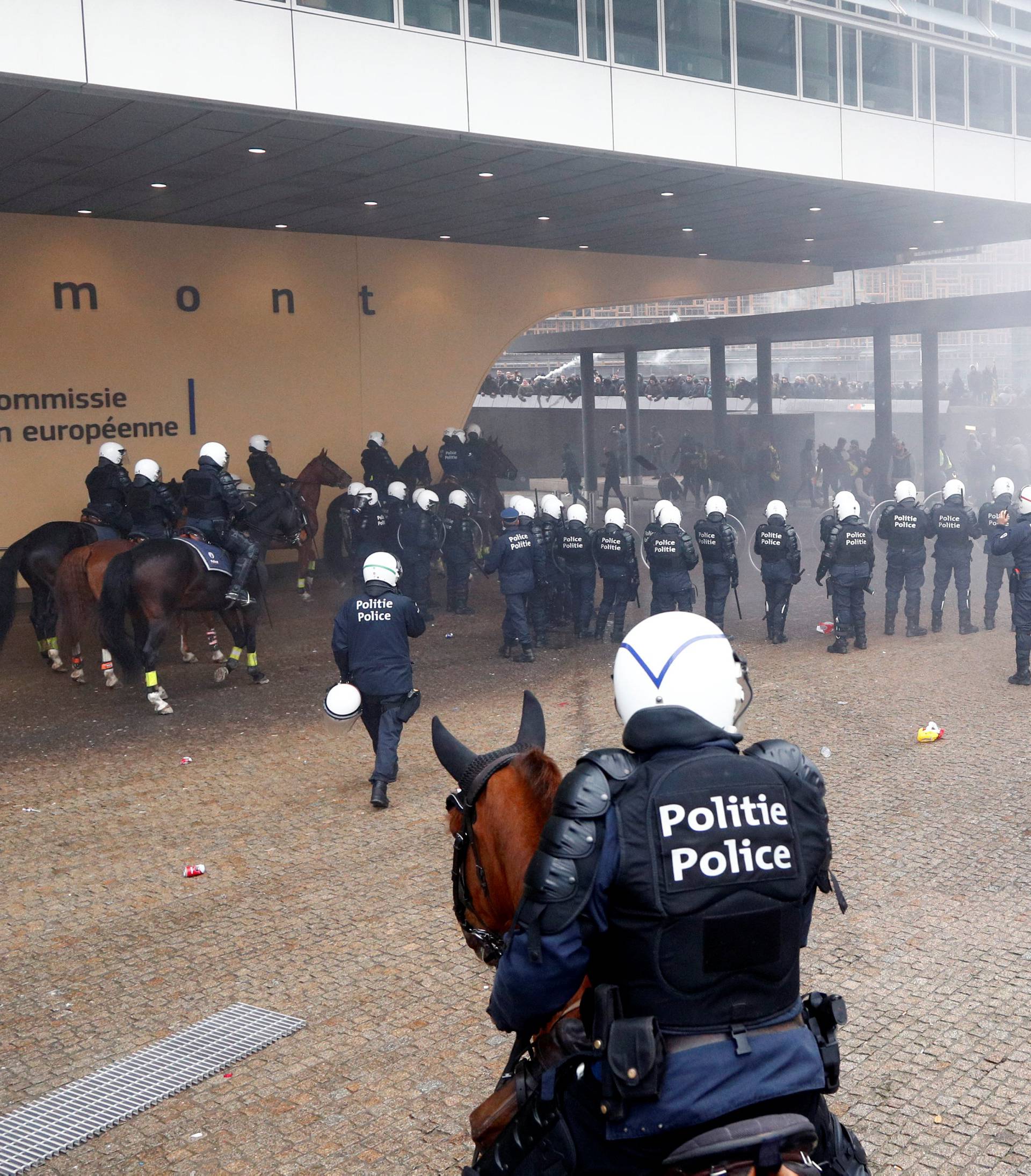 Police officers and mounted police face off with far-right supporters during a protest against Marrakesh Migration Pact, outside European Commission headquarters, in Brussels