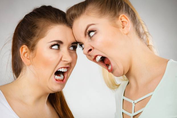 Two agressive women having argue fight