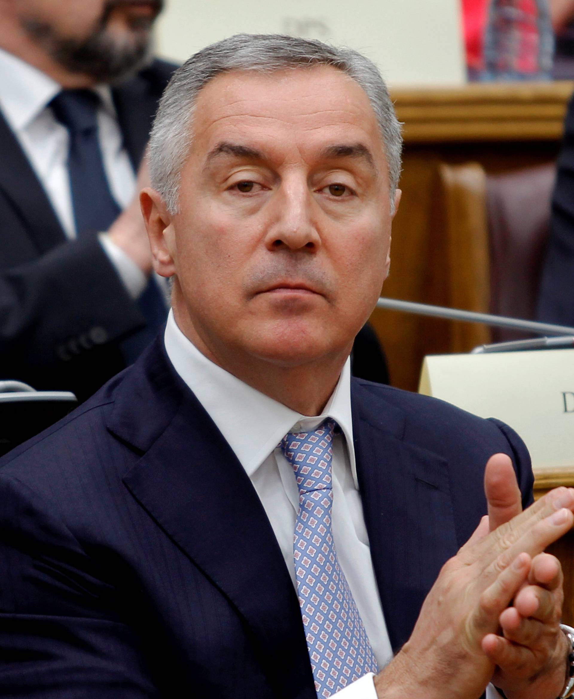 President of a ruling Democratic Party of Socialist (DPS), former prime minister and president of Montenegro, Milo Djukanovic applauds during a parliament discussion on NATO membership agreement in Cetinje