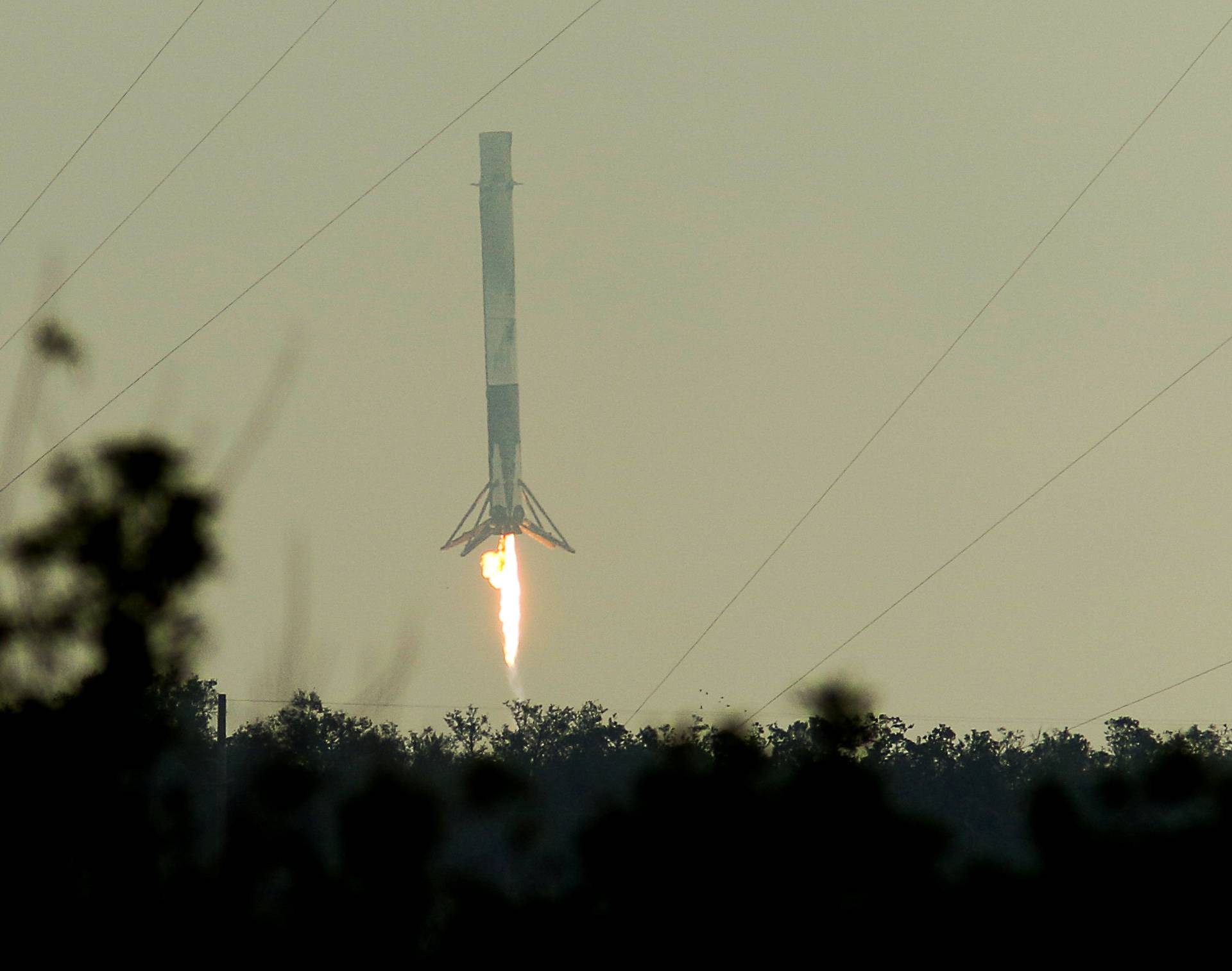 A SpaceX Falcon 9 rocket first stage returns to land at the Cape Canaveral Air Force Station in Cape Canaveral