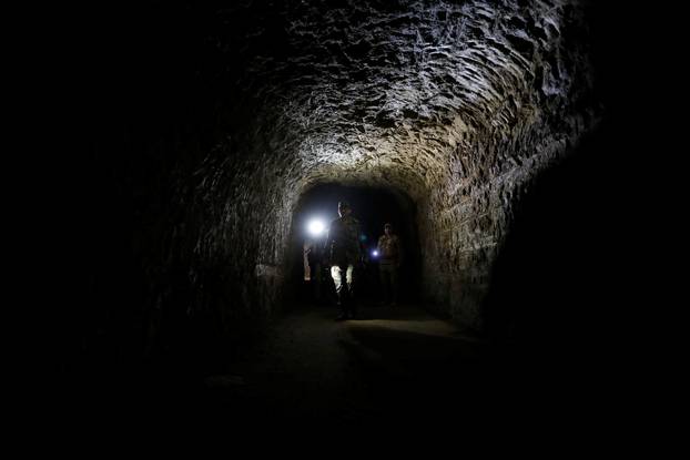 Member of Syrian forces of President Bashar al Assad walks inside a tunnel that was used by rebels in Jobar, eastern Ghouta, in Damascus