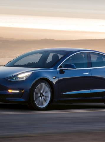 A Tesla Model 3 sedan is seen in this undated handout image as the car company handed over its first 30 Model 3 vehicles to employee buyers at the companyâs Fremont facility