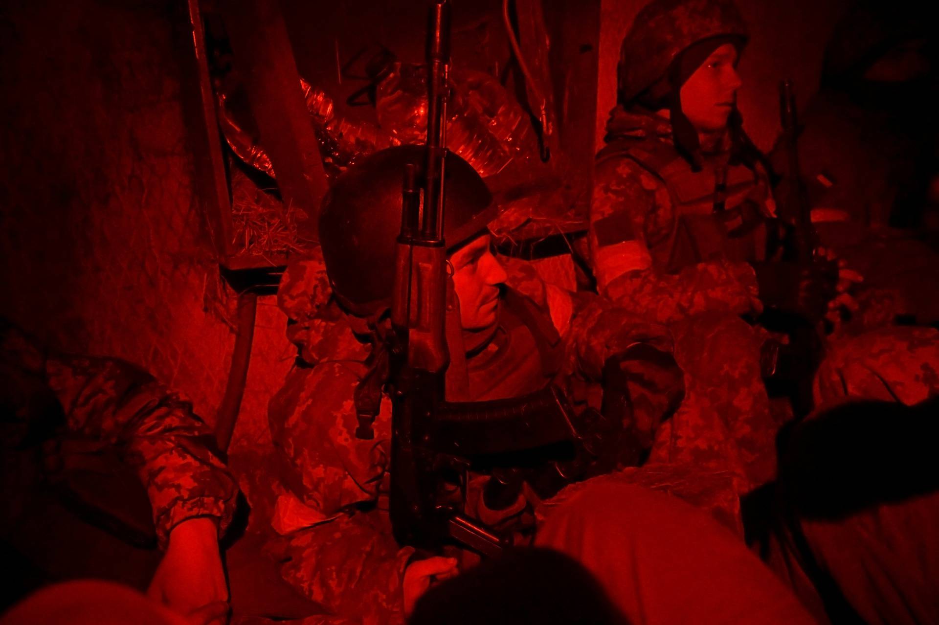 Ukrainian servicemen take cover in a shelter at fighting positions at the military airbase Vasylkiv in the Kyiv region