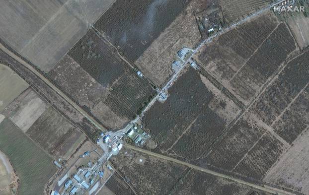A satellite image shows refugees and cars waiting to cross into Hungary from Ukraine, at the Luzhanka Border crossing