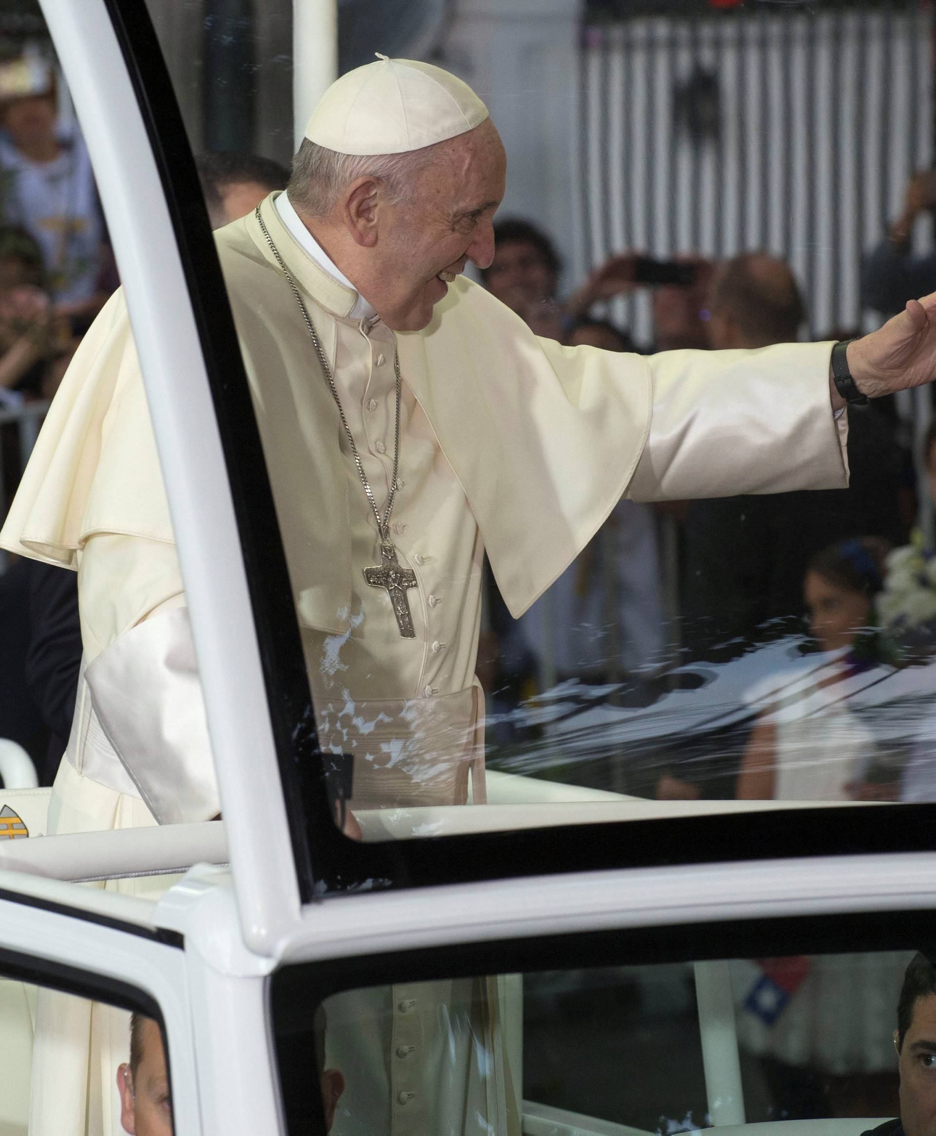 Pope Francis waves while arriving at the nunciature in Santiago