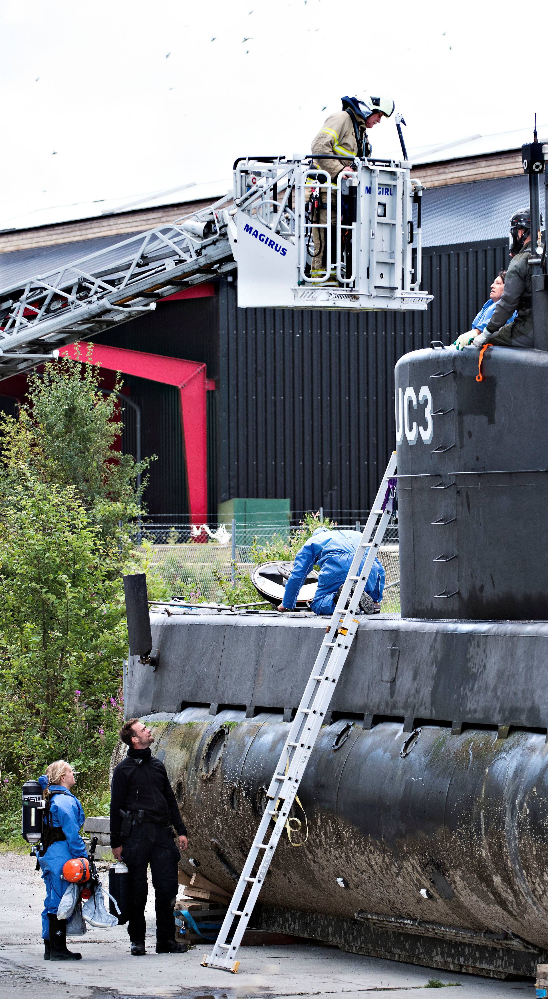 Police technicians investigate the rescued private submarine "UC3 Nautilus" in Copenhagen Harbor