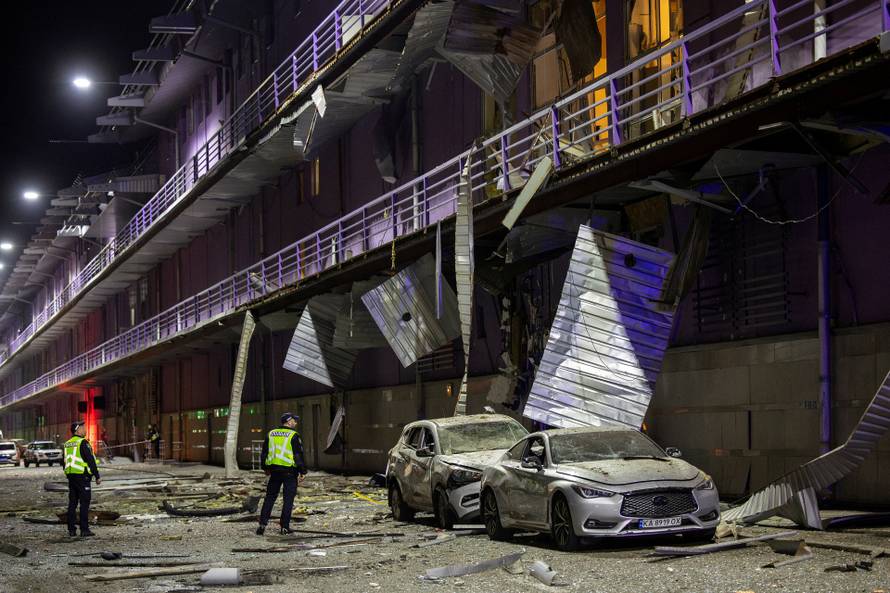 Policemen inspect a shopping mall that was damaged during a Russian drone attack in Kyiv