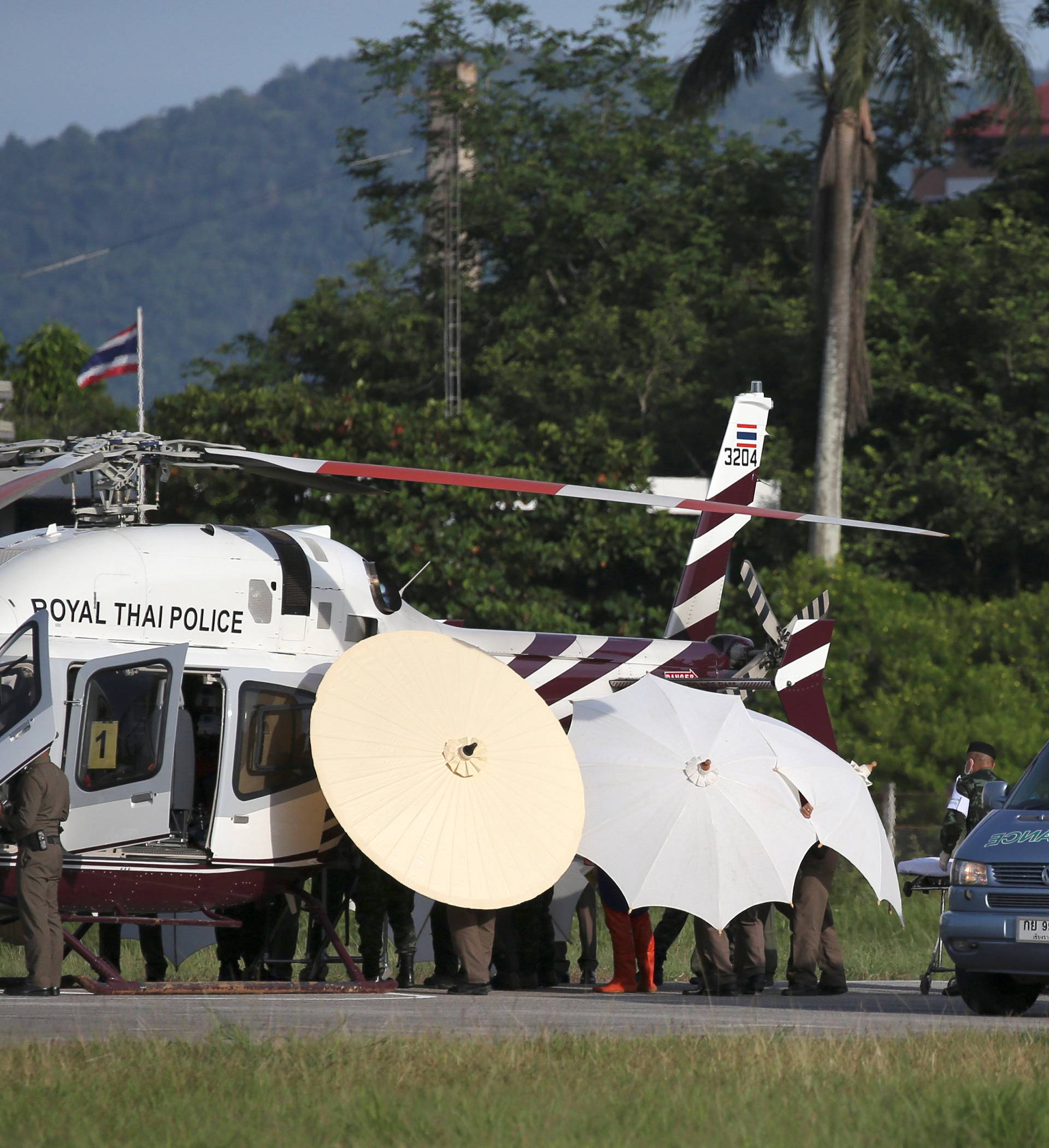 Rescued schoolboys are moved from a Royal Thai Police helicopter to an awaiting ambulance at a military airport in Chiang Rai