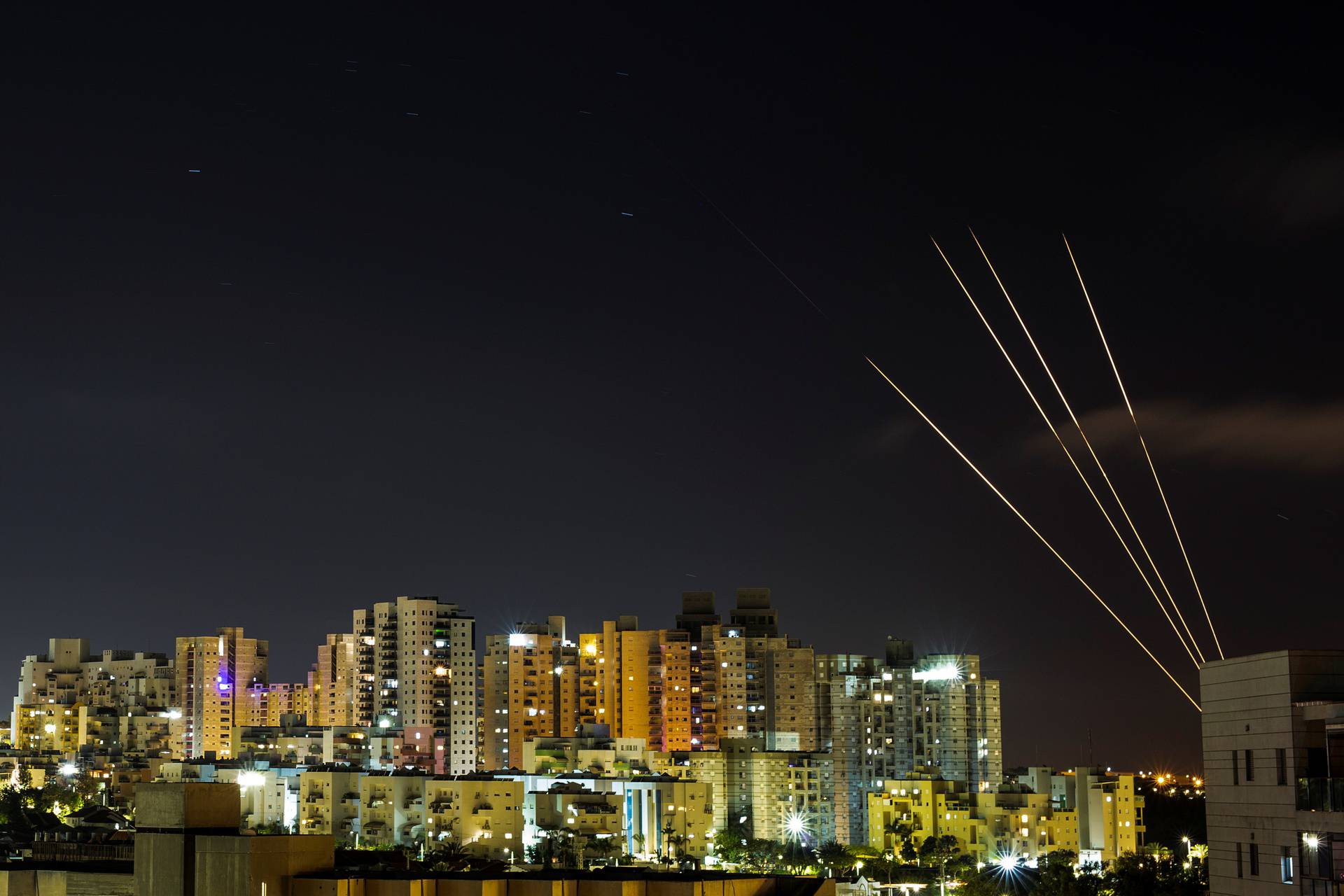 Streaks of light are seen as Israel's Iron Dome anti-missile system intercepts rockets launched from the Gaza Strip towards Israel, as seen from Ashkelon, Israel