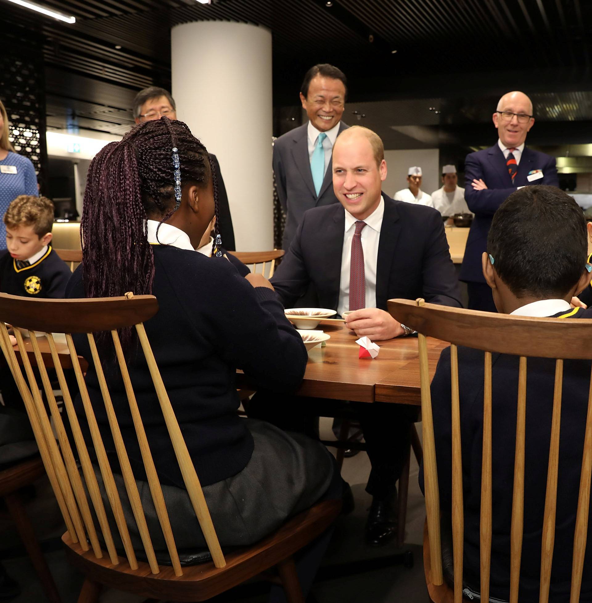 Britain's Prince William joins local school children from St Cuthbert with St Matthias CE Primary School at a copper beating workshop during the official opening of Japan House in London