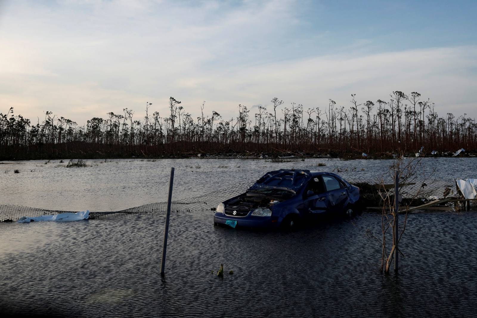 A cars is seen in a flooded parking lot in a facility next to the Leonard M. Thompson International Airport after hurricane Dorian hit the Abaco Islands in Marsh Harbour