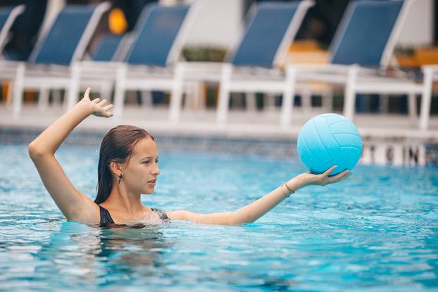 Teen girl swimming in pool