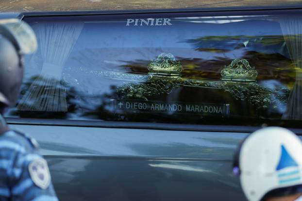 The car carrying the casket of soccer legend Diego Maradona arrives at the cemetery in Buenos Aires, Argentina