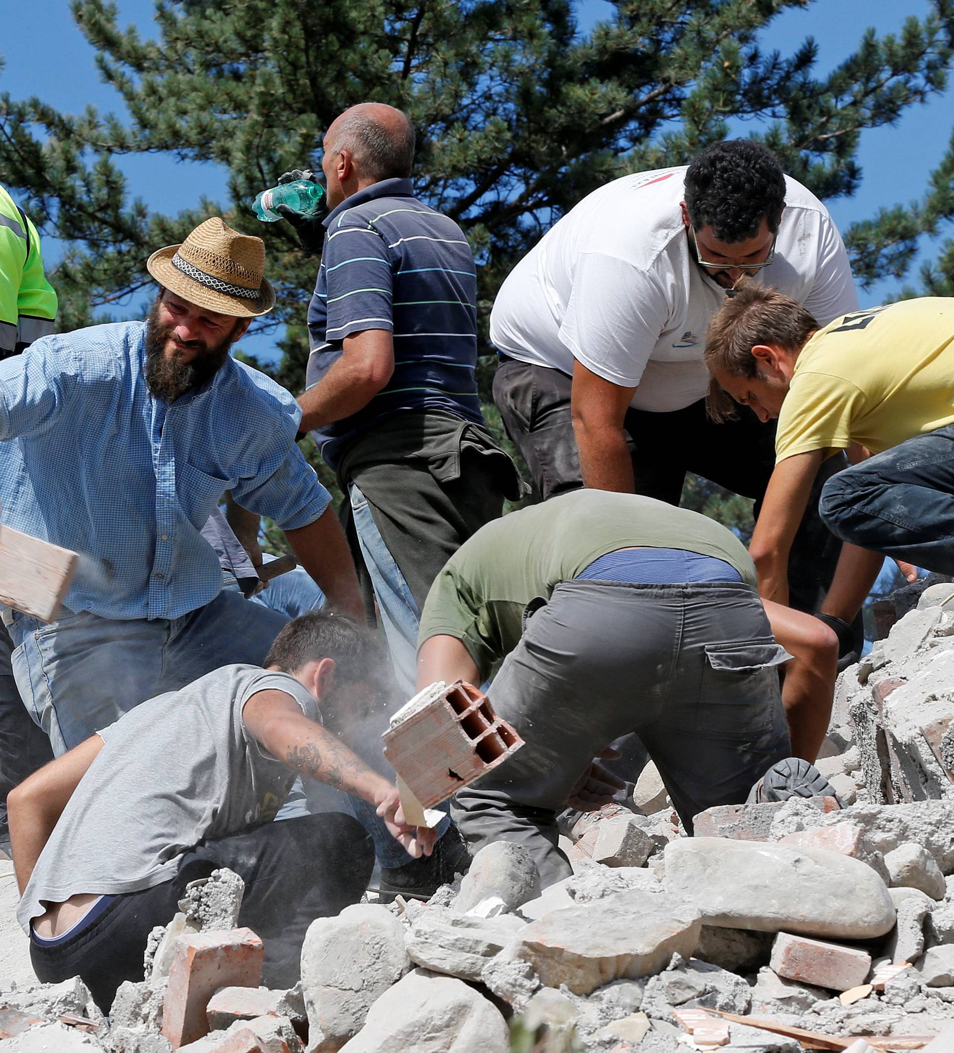 Rescuers work on a collapsed building following an earthquake in Amatrice