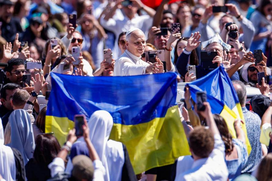 Pope Leo XIV delivers his "Urbi et Orbi" (To the city and the world) message from the main balcony of St. Peter's Basilica