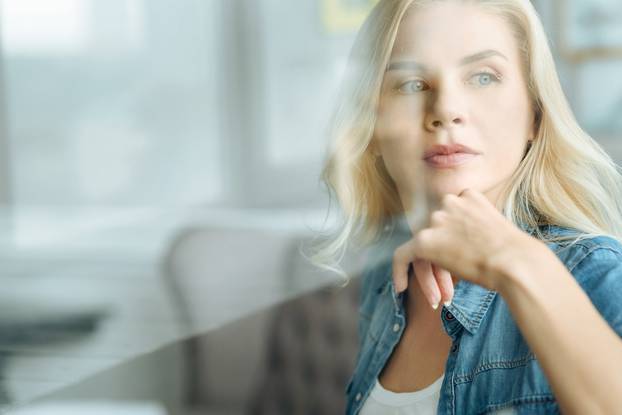 Portrait of pretty woman sitting in a living room