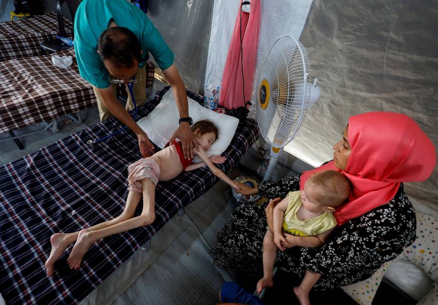 FILE PHOTO: Malnourished Palestinian children receive treatment at the IMC field hospital in Deir Al-Balah, central Gaza Strip