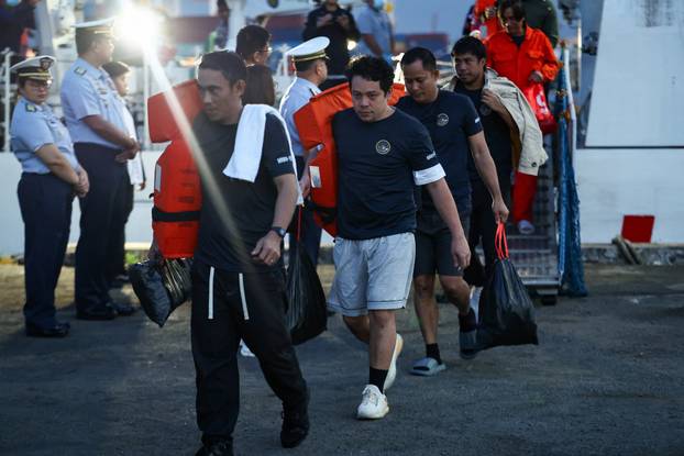 Seafarers who survived the sinking of the cargo ship M/V Devon Bay return to Manila