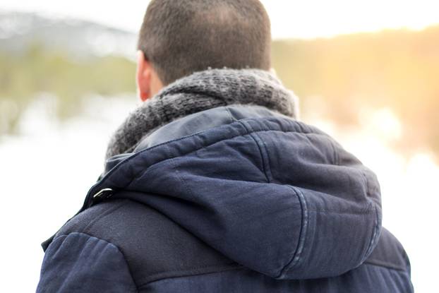 Man with hooded back and scarf