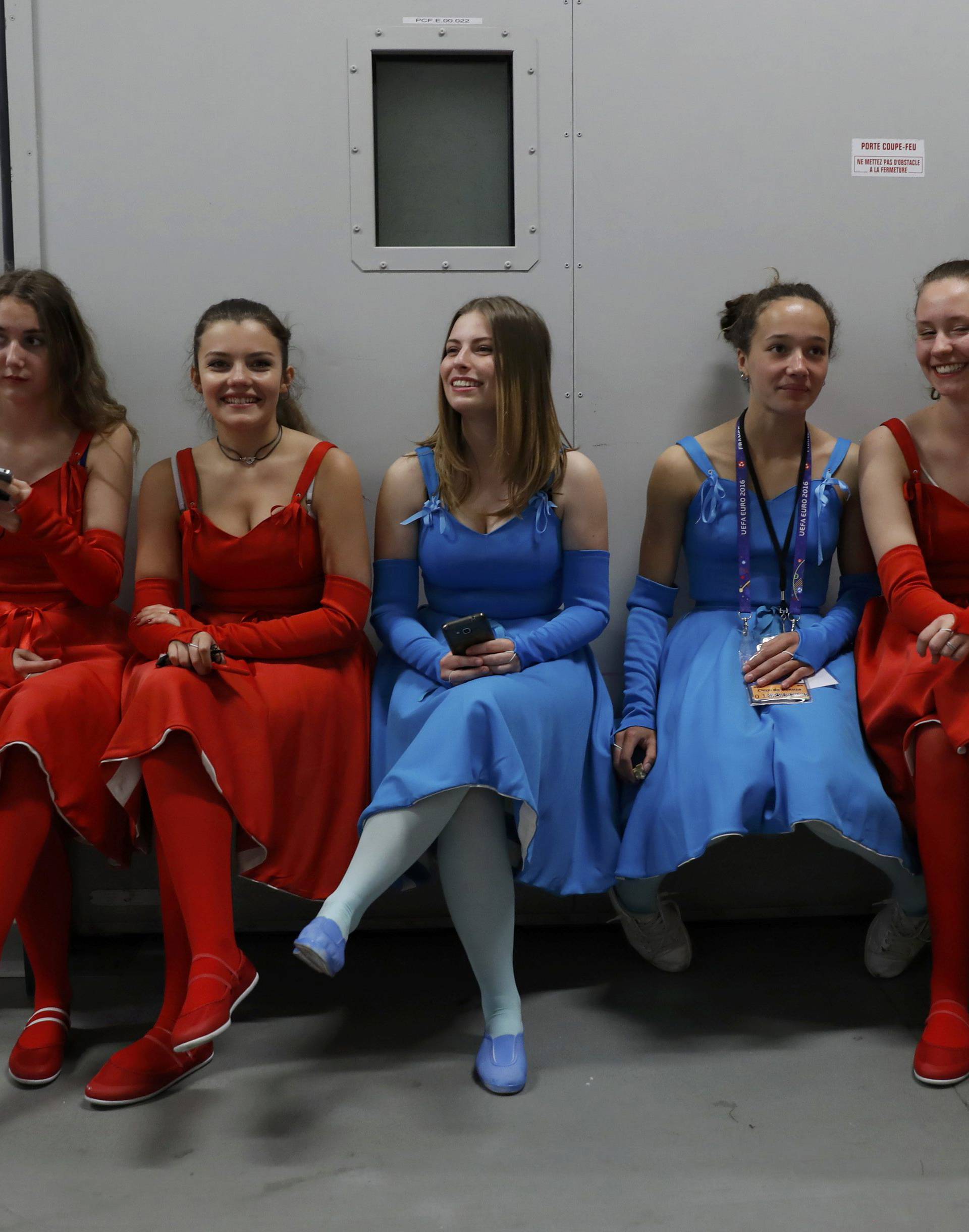 Dancers sit backstage before rehearsal for opening show of the UEFA 2016 European Championship in Paris