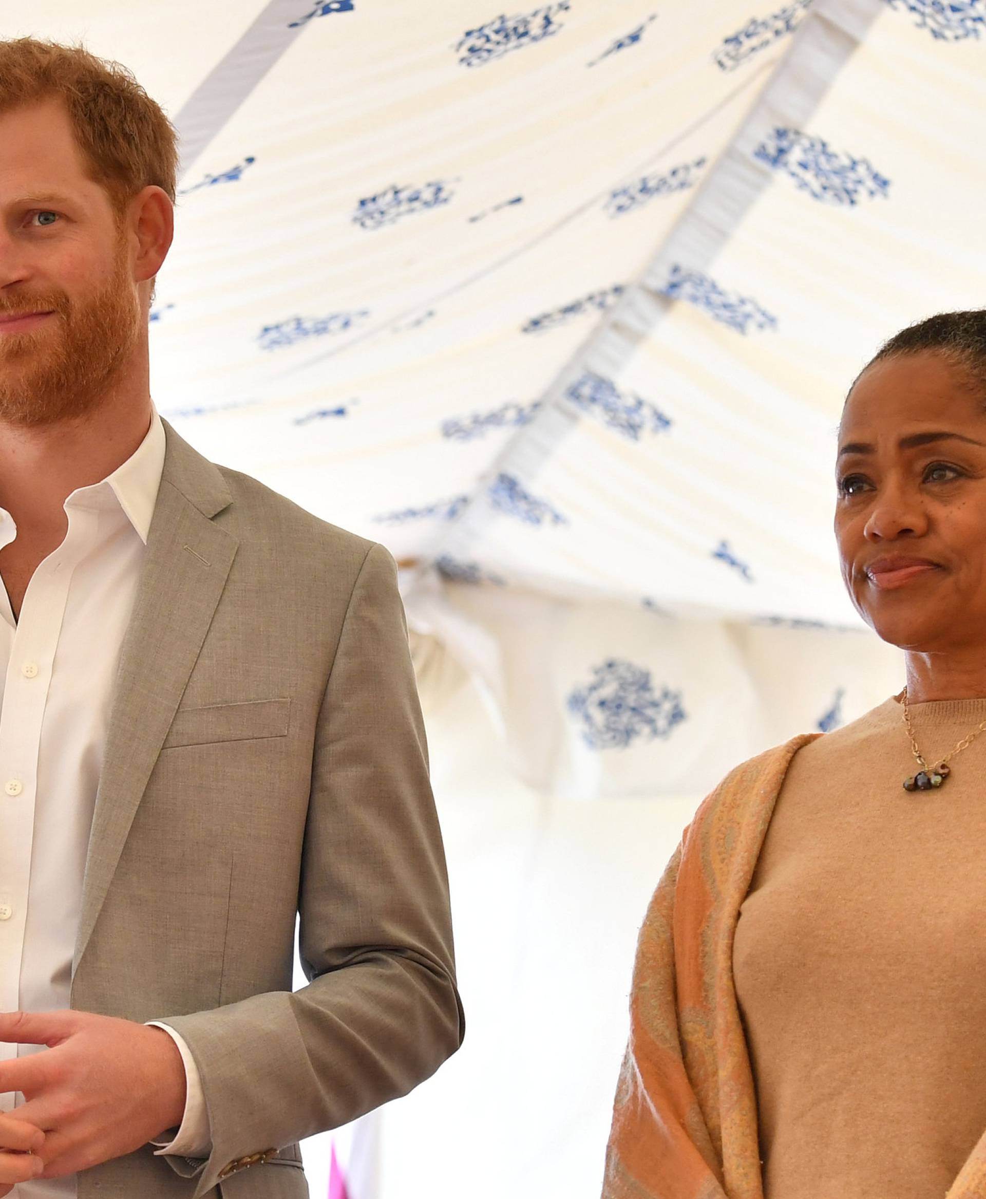 Britain's Prince Harry, and Doria Ragland listen to Meghan, Duchess of Sussex speaking at the launch of a cookbook with recipes from a group of women affected by the Grenfell Tower fire at Kensington Palace in London