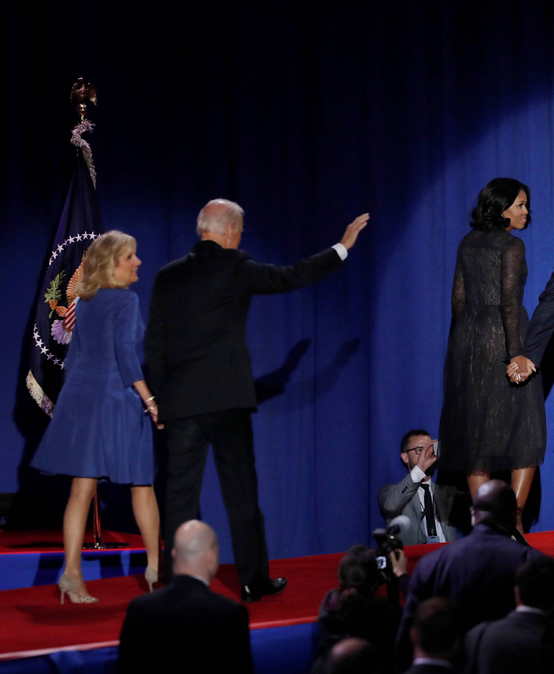 U.S. President Barack Obama, his wife Michelle, their daughter Malia, Vice-President Joe Biden and his wife Jill acknowledge the crowd in Chicago