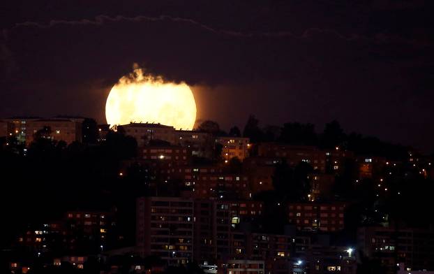A supermoon rises in the sky at the city of Vina del Mar