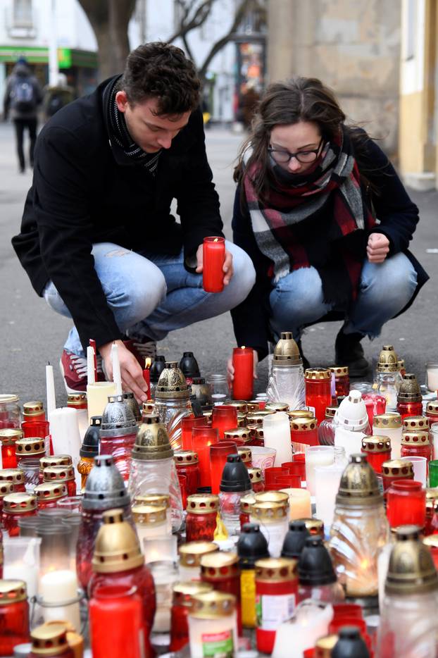 People light candles for a tribute to murdered Slovak investigative reporter Jan Kuciak at Slovak National Uprising Square in Bratislava